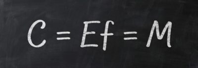 Eastwood's primary Internal Science equation written on a university blackboard, "C=Ef=M™"